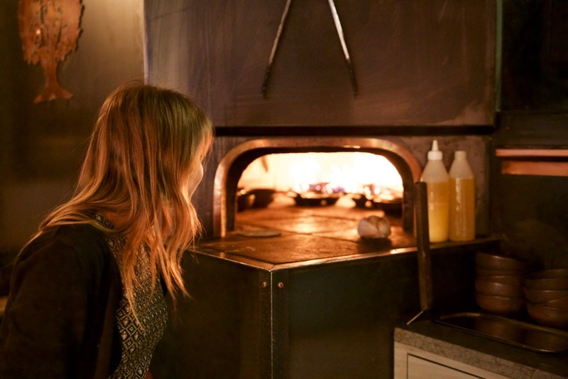 Peering into the wood burning oven at Ekstedt Restaurant, Stockholm