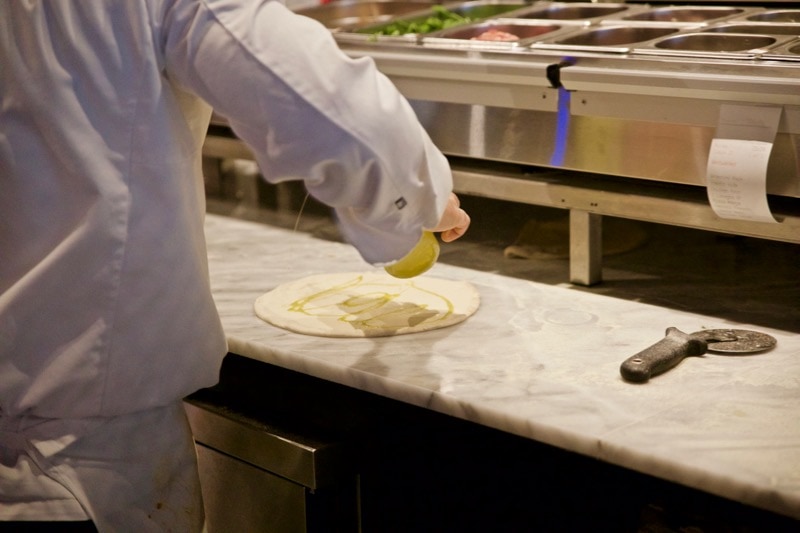 Chef preparing fresh pizza at Obicà Restaurant, St Paul's, London