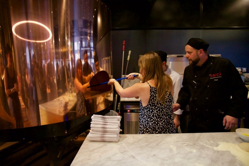 Attempting to put the pizza in the oven at Obicà Restaurant, St Paul's, London