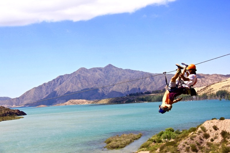 @BackpackerMacca ziplining upside-down over Lake Potrerillos in Argentina
