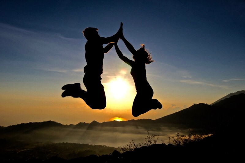 We did it! Jumping over the sun at the top of Mount Batur, Bali