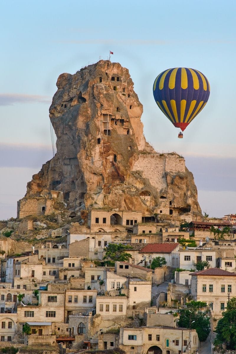 Hot air balloons in front of Uchisar Castle, Cappadocia