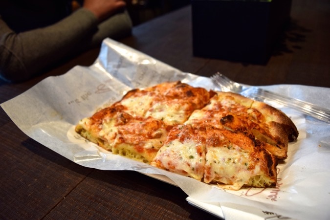 Enjoying pizza at the end of our Milan food tour