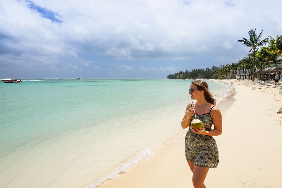 Enjoying fresh coconuts on the beach at Heritage Le Telfair, Mauritius