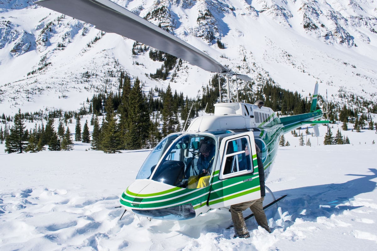 Helicopter in the snowy river valley in Alberta, Canada