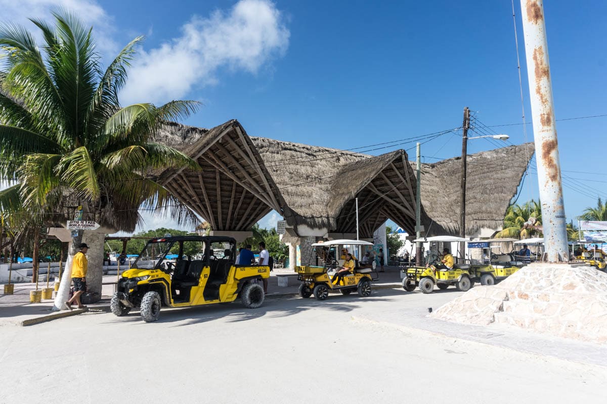 Golf buggies waiting at Holbox Ferry Port