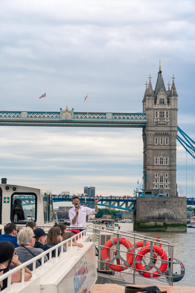 Travelling under Tower Bridge on an afternoon tea river cruise in London 