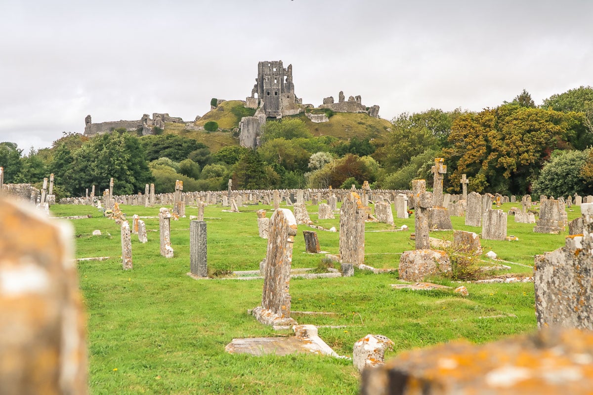 Graveyard in Corfe Castle with ruins in the background