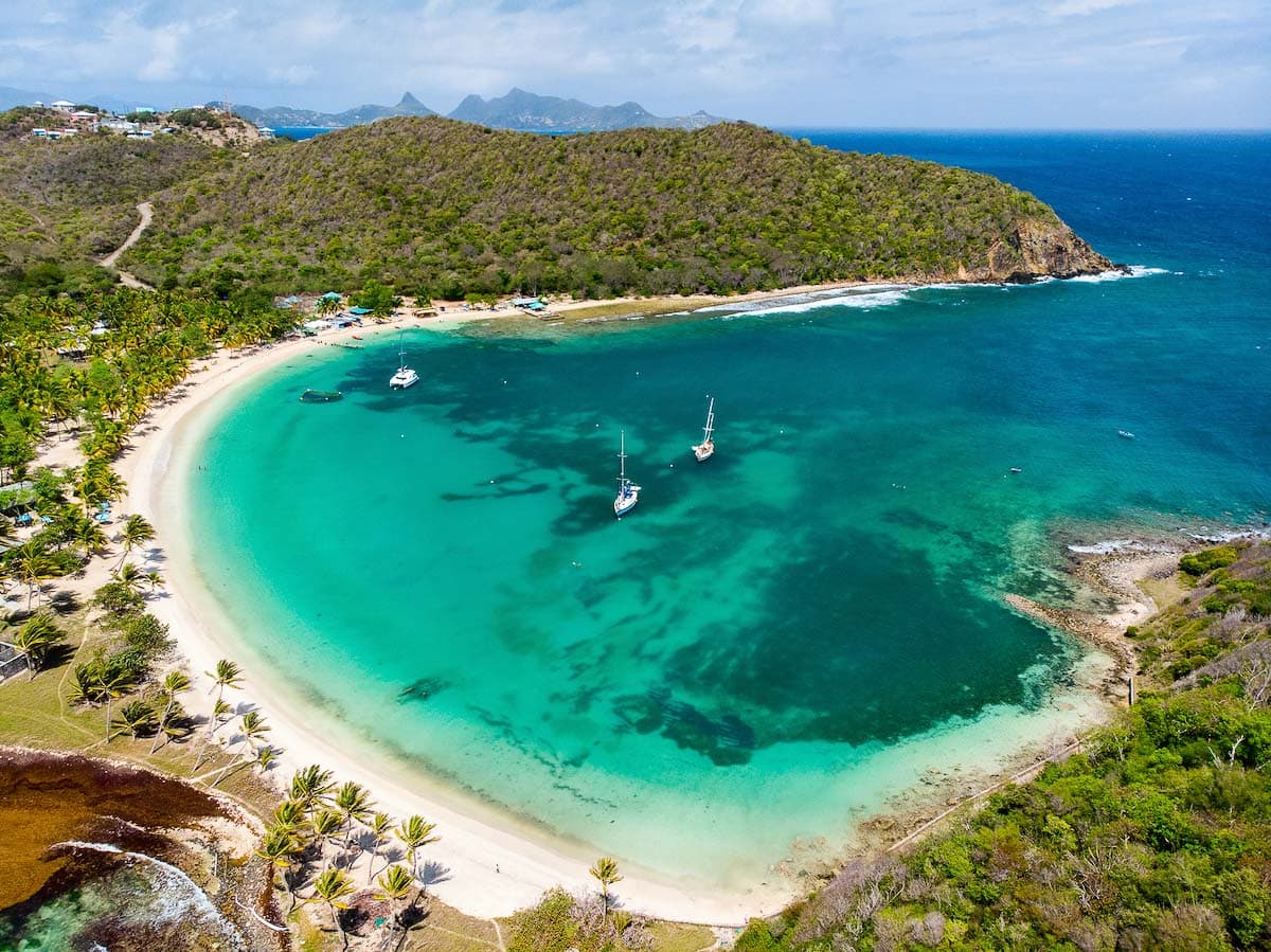 Aerial drone view of tropical island of Mayreau and turquoise Caribbean sea in St Vincent and Grenadines