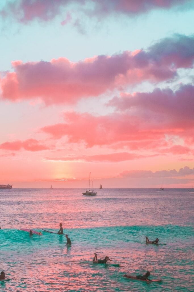 Surfers at sunset in Maui