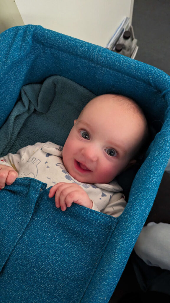 baby in plane bassinet