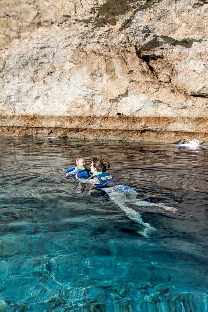 swimming in cenote with baby